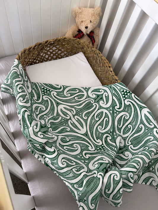 Āhuru Swaddle in Pounamu colourway – Māori-inspired organic cotton baby swaddle by Hiwa & Awa Co.